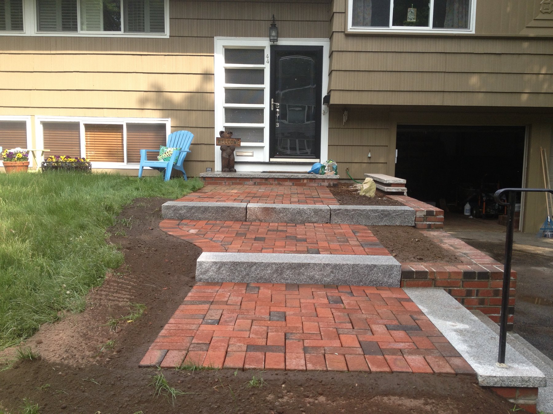 CDK Masonry Finished walkway and integrated granite steps beside the entry