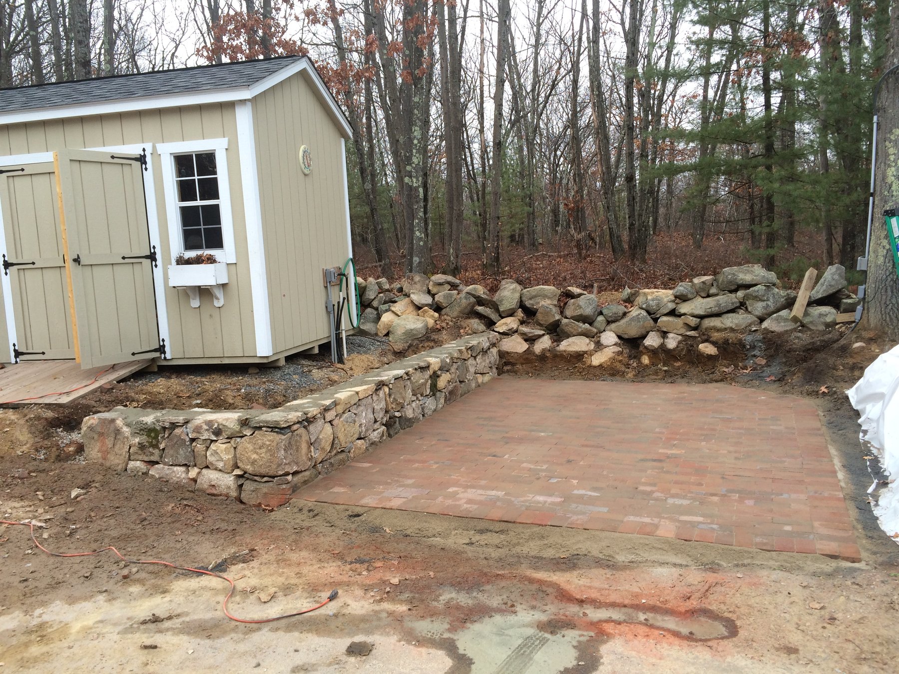 Dry-Stacked Fieldstone Sitting Wall & Clay Brick Patio — Southboro, MA