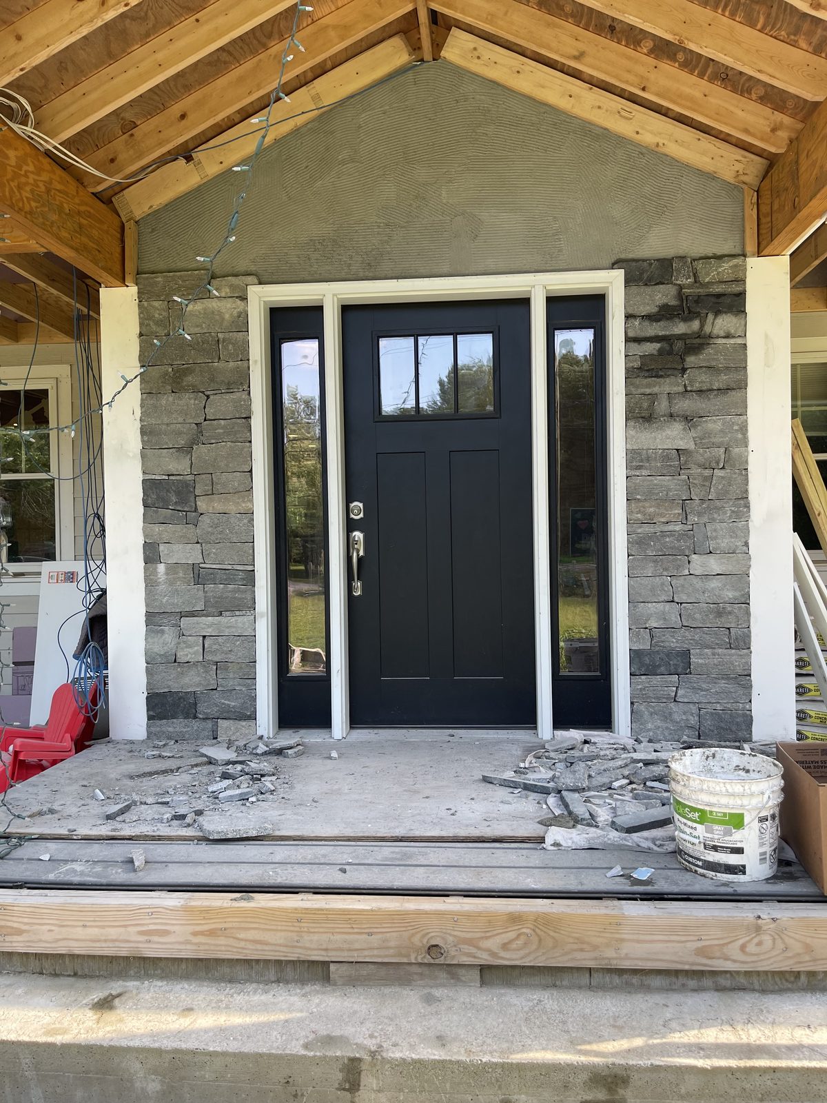 Stone veneer progressing around the front entry in Bolton Massachusetts